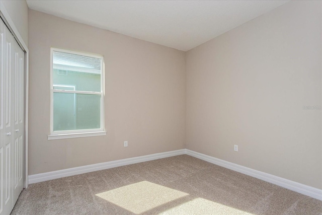 carpeted empty room with a wealth of natural light