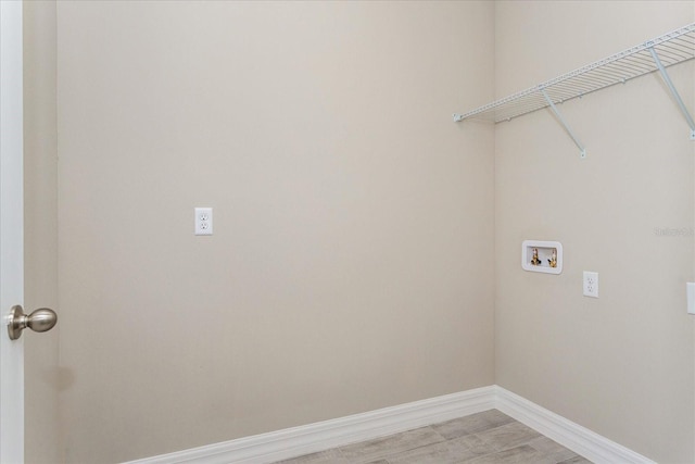 laundry room featuring washer hookup and light wood-type flooring