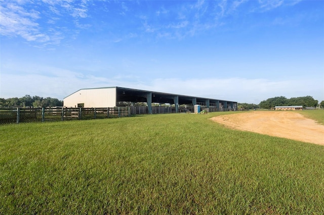 view of yard with an outbuilding and a rural view