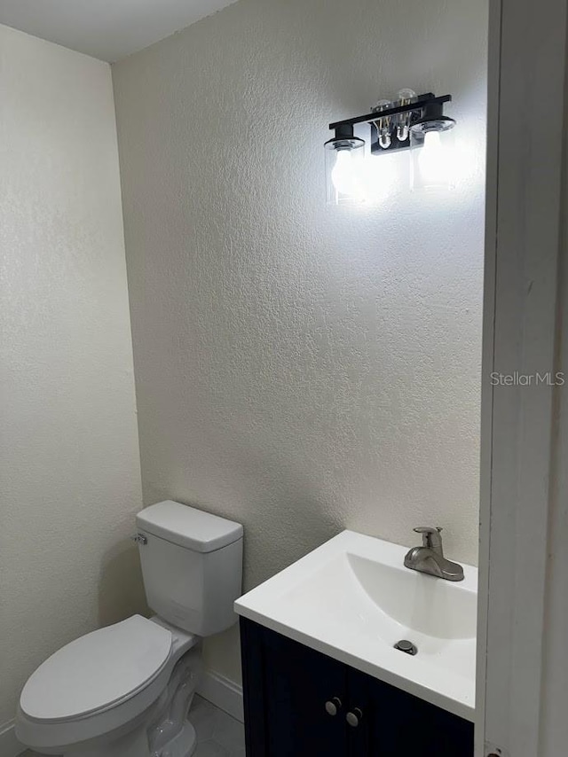 bathroom featuring toilet and vanity