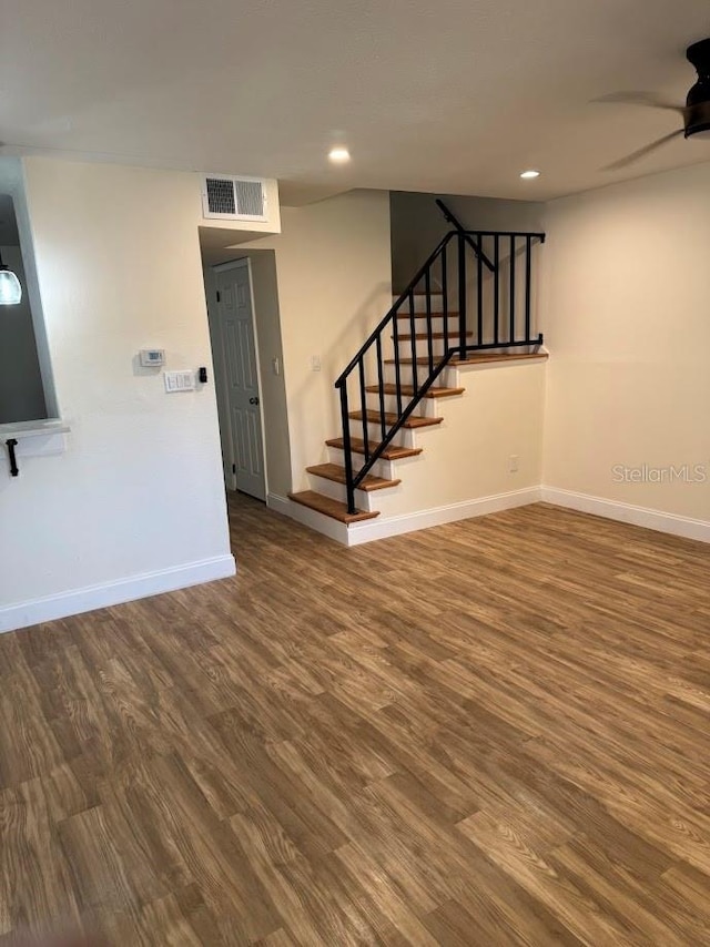 interior space featuring ceiling fan and dark wood-type flooring