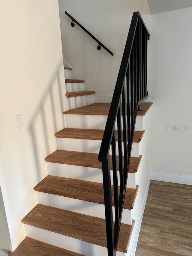 stairway with dark wood-type flooring