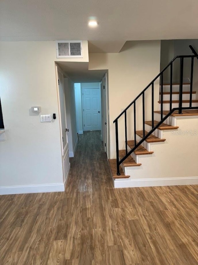 hallway with dark wood-type flooring