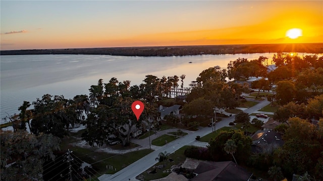 aerial view at dusk with a water view