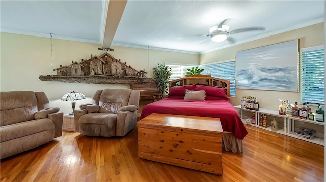 bedroom with ceiling fan, ornamental molding, and hardwood / wood-style floors