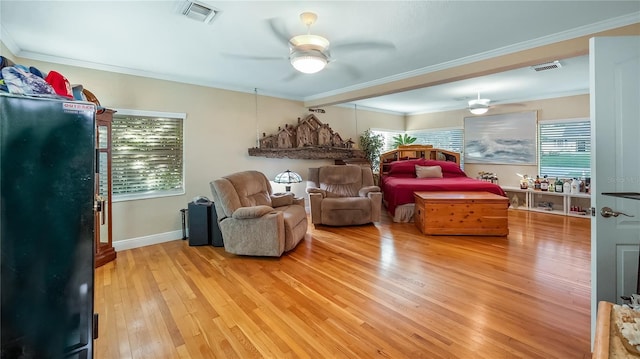 sitting room featuring ceiling fan, ornamental molding, and light hardwood / wood-style flooring