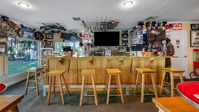 bar featuring a textured ceiling