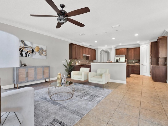 tiled living room featuring ceiling fan and ornamental molding