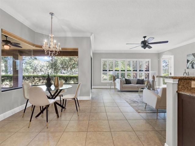 tiled dining area with ceiling fan with notable chandelier, ornamental molding, and a textured ceiling