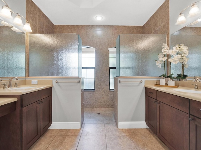 bathroom with tile patterned floors, vanity, and walk in shower