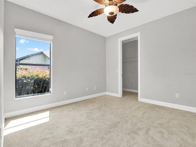 unfurnished bedroom with ceiling fan, light carpet, and a closet