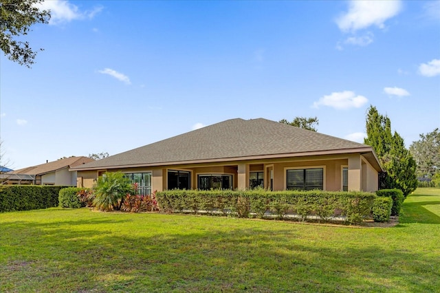 rear view of property with a yard