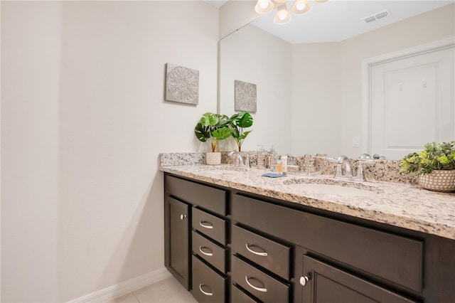 bathroom featuring tile patterned flooring and vanity