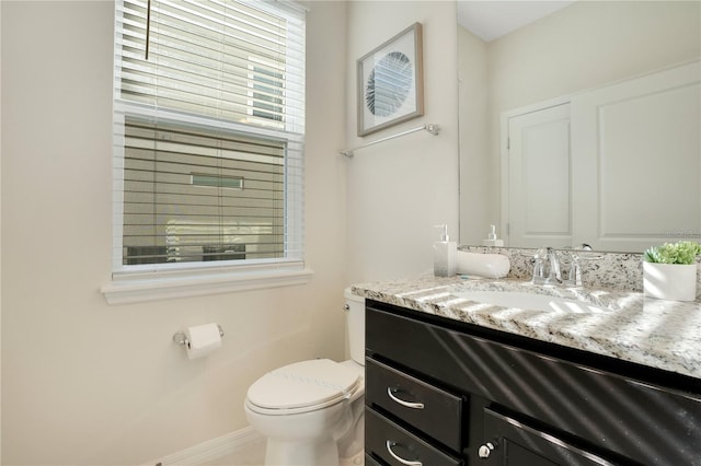 bathroom featuring toilet and vanity