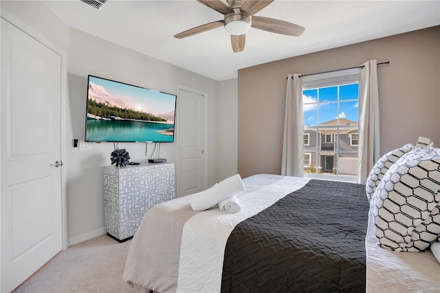 bedroom with ceiling fan and light colored carpet