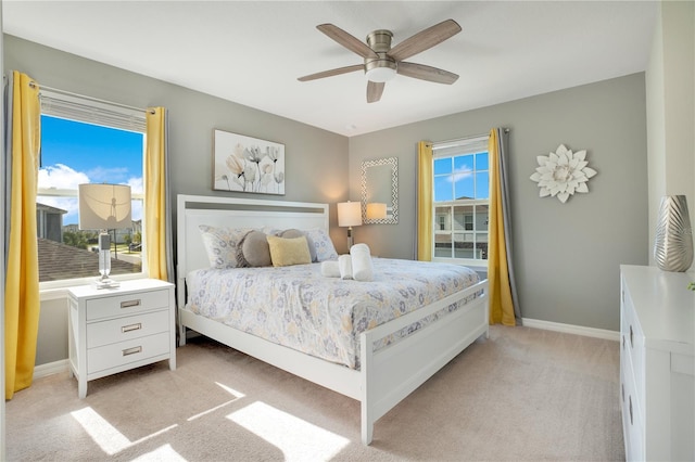 bedroom featuring ceiling fan and light carpet