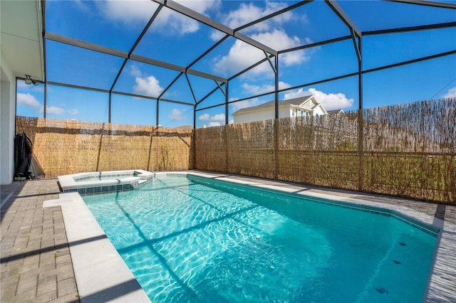 view of pool featuring an in ground hot tub, a lanai, and a patio area