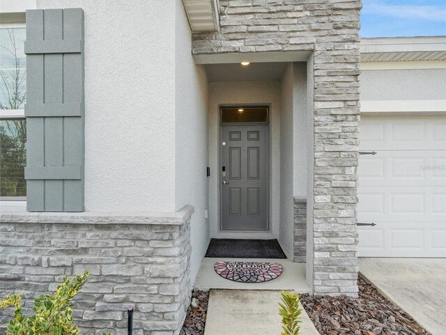 view of exterior entry featuring a garage