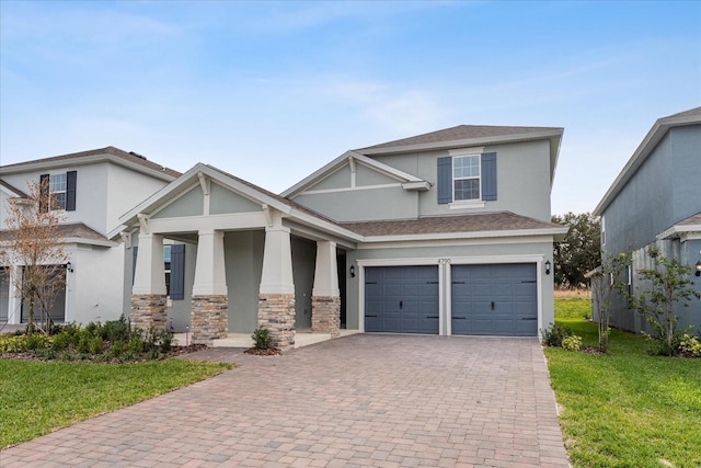 view of front of home featuring a garage, a front lawn, decorative driveway, and stucco siding