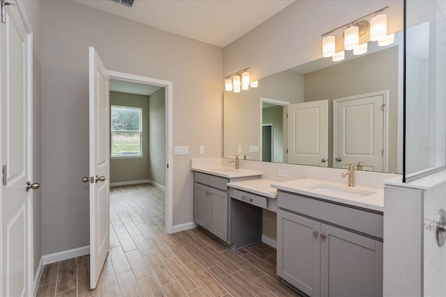 bathroom featuring baseboards, vanity, and wood tiled floor