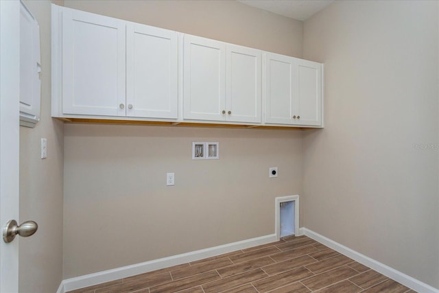 clothes washing area featuring hookup for a washing machine, hookup for an electric dryer, hardwood / wood-style floors, and cabinets