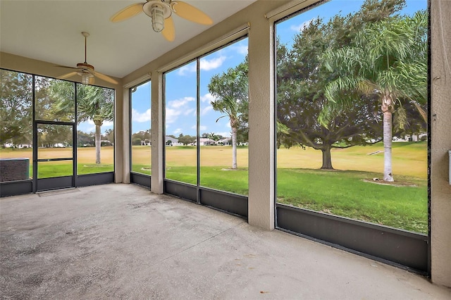 unfurnished sunroom featuring ceiling fan