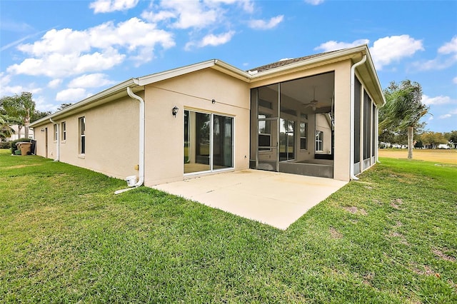 rear view of property featuring a sunroom, a lawn, and a patio area