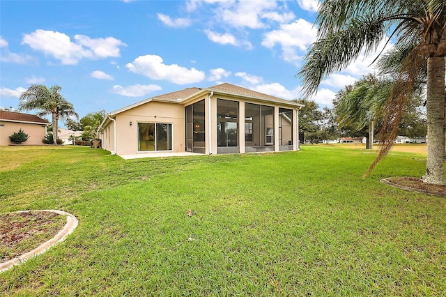 rear view of property featuring a sunroom and a yard