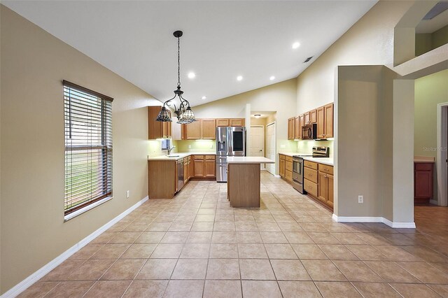 kitchen with stainless steel appliances, hanging light fixtures, a center island, and light tile patterned floors