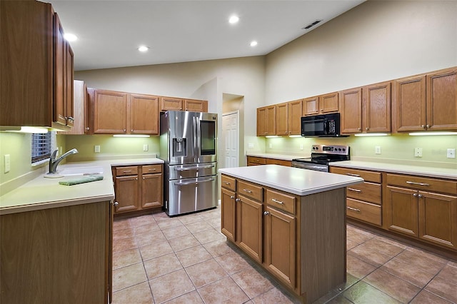 kitchen featuring stainless steel appliances, a kitchen island, sink, and light tile patterned floors