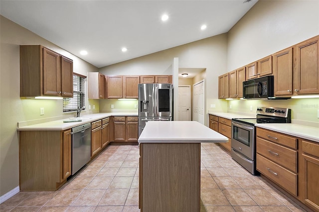 kitchen with light tile patterned flooring, lofted ceiling, appliances with stainless steel finishes, and a center island