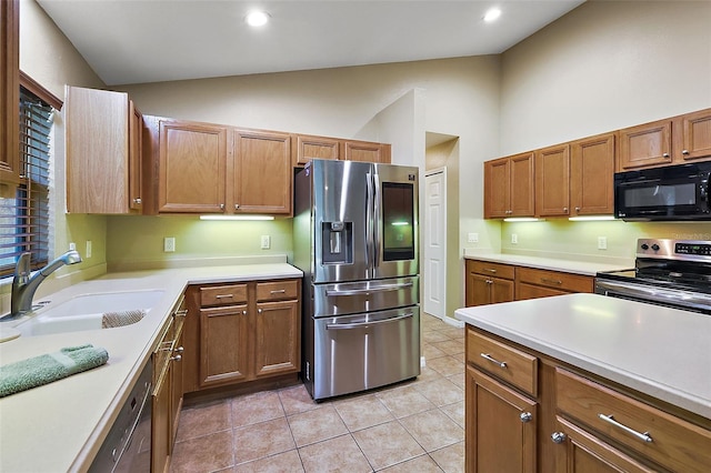 kitchen with sink, light tile patterned floors, high vaulted ceiling, and black appliances