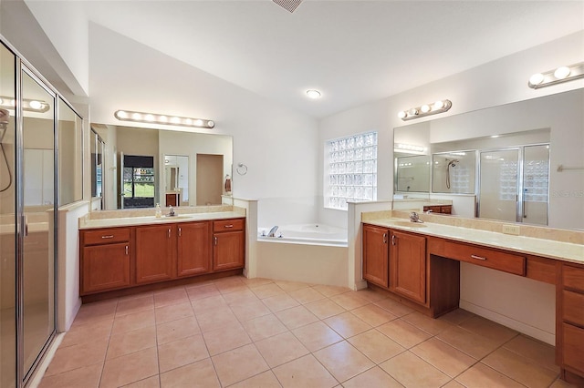 bathroom with shower with separate bathtub, vaulted ceiling, tile patterned floors, and vanity