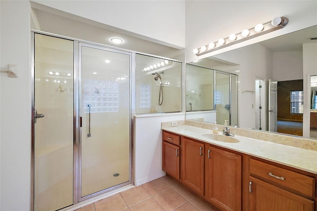 bathroom with tile patterned flooring, vanity, and a shower with door