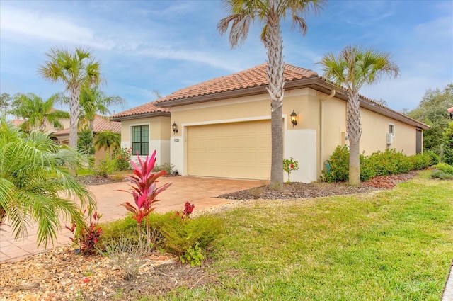 mediterranean / spanish home featuring a garage and a front lawn