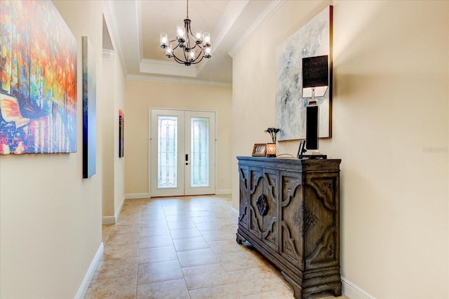 entryway with french doors, a notable chandelier, and crown molding