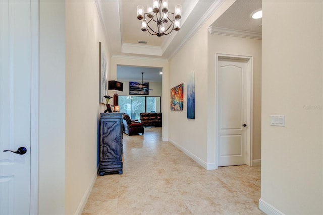 hall with crown molding and a notable chandelier