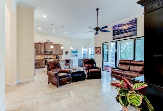 living room featuring ornamental molding, ceiling fan with notable chandelier, and light tile patterned floors