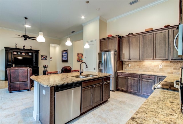 kitchen with dark brown cabinetry, an island with sink, sink, decorative light fixtures, and stainless steel appliances