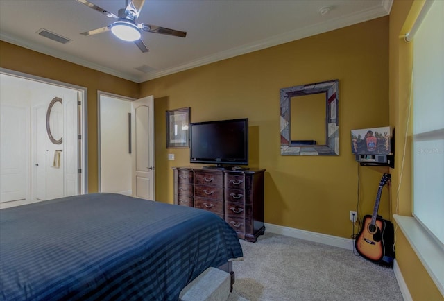 carpeted bedroom with ceiling fan and ornamental molding