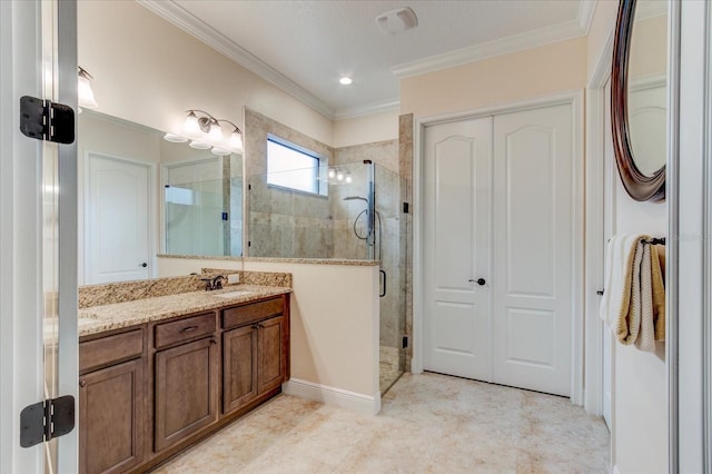 bathroom with walk in shower, crown molding, and vanity