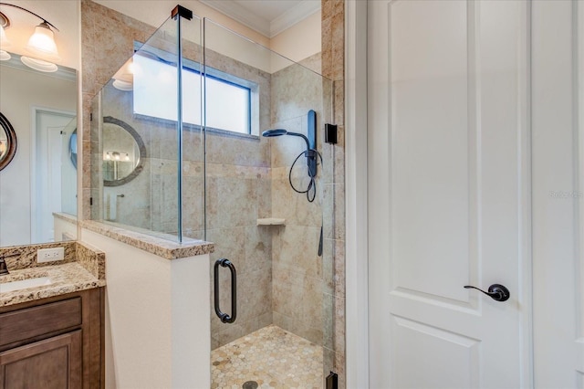 bathroom featuring a shower with door, vanity, and crown molding