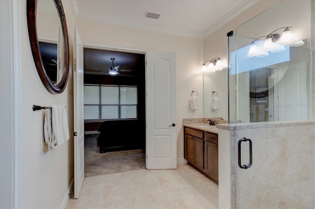 bathroom with ceiling fan, vanity, a shower with shower door, and ornamental molding