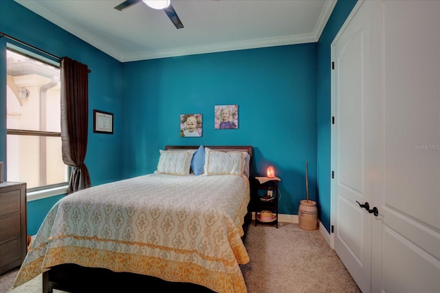 carpeted bedroom with ceiling fan and crown molding