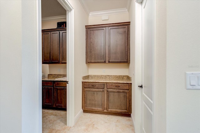 hall featuring ornamental molding and light tile patterned floors