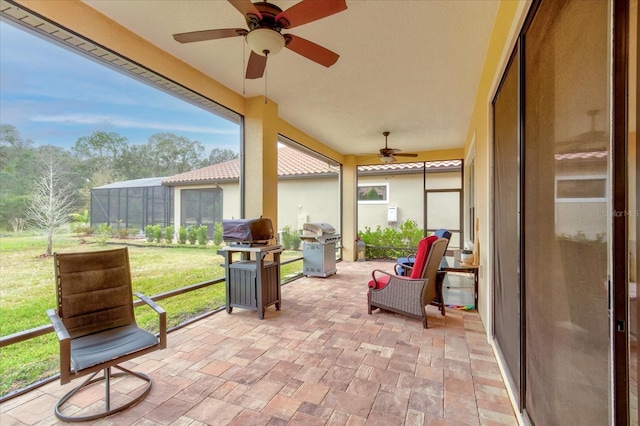 sunroom featuring ceiling fan