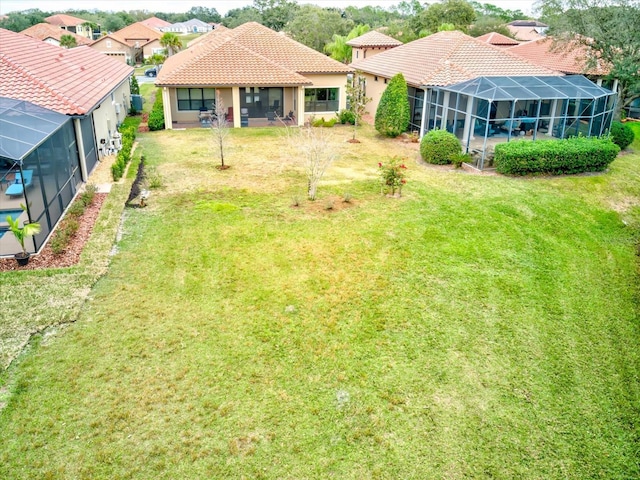 view of yard with glass enclosure