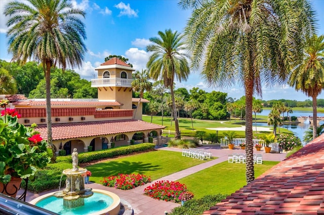 view of property's community with a yard and a water view