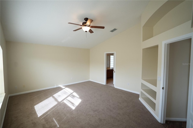 spare room featuring vaulted ceiling, carpet floors, and ceiling fan