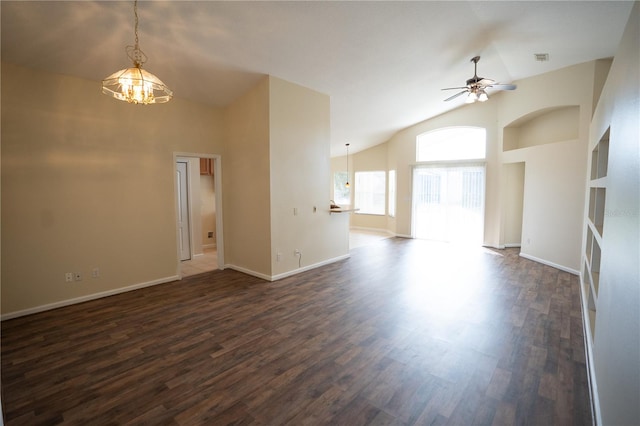 unfurnished living room with high vaulted ceiling, dark hardwood / wood-style flooring, and ceiling fan with notable chandelier